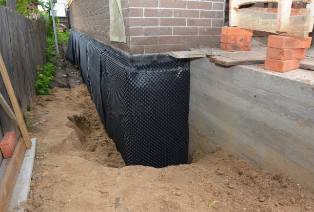 Happy homeowners after waterproofing job in Eight Mile